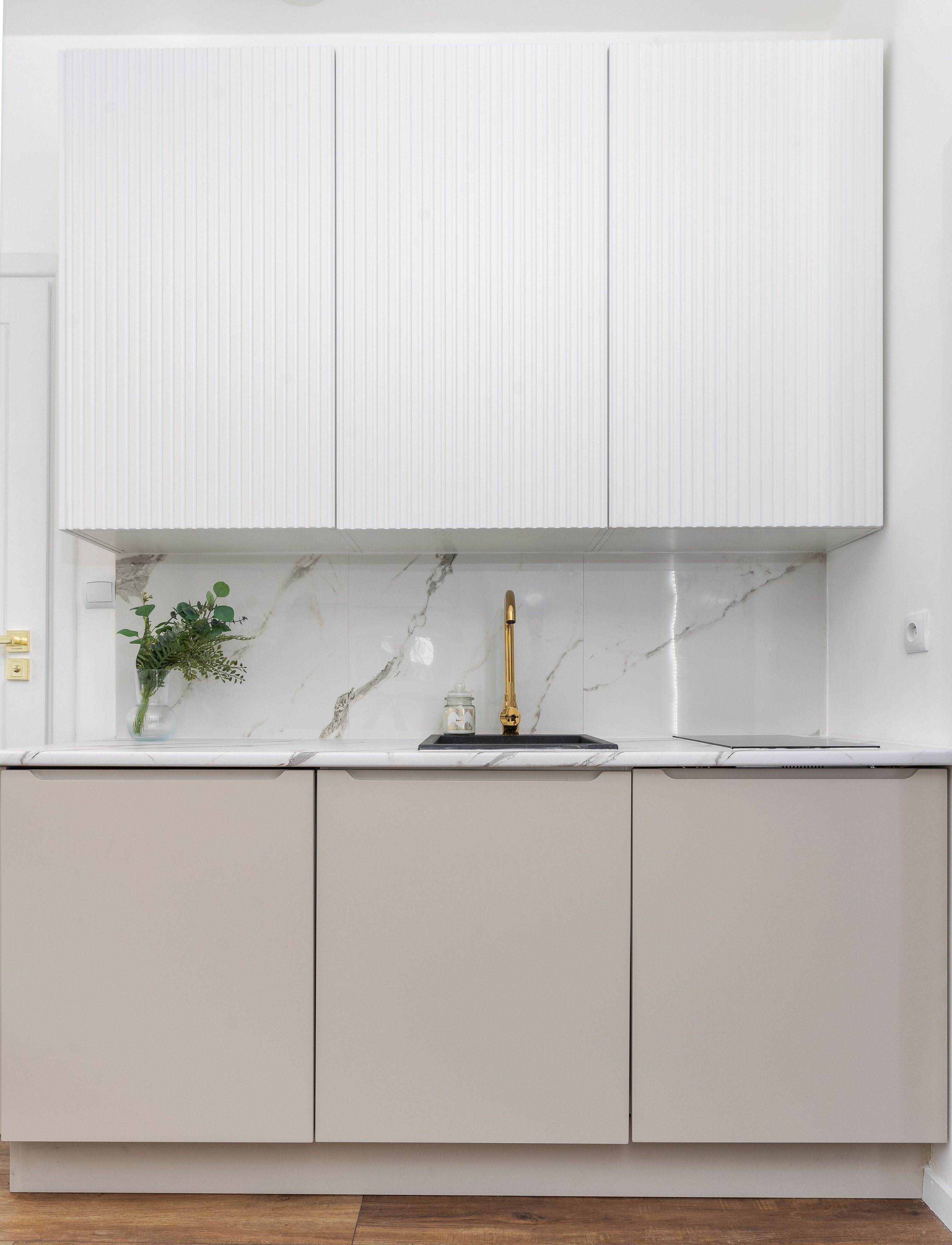 Kitchen detail with marble backsplash and gold fixtures