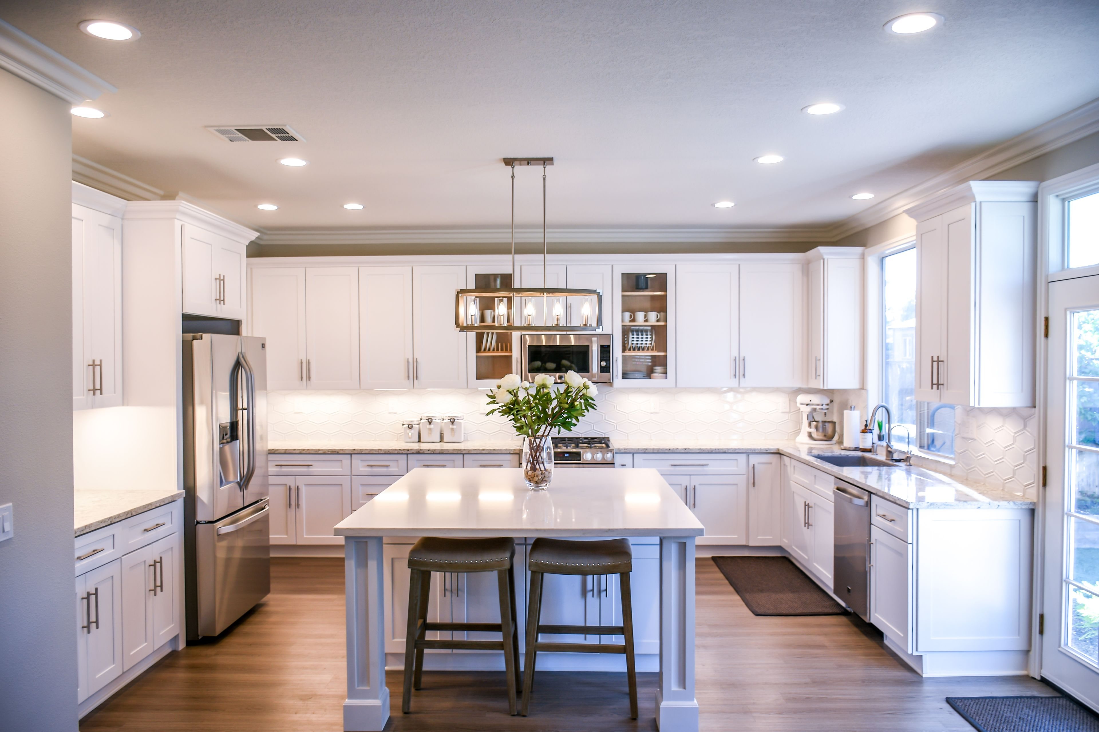Bright white chef's kitchen with island and pendant lighting