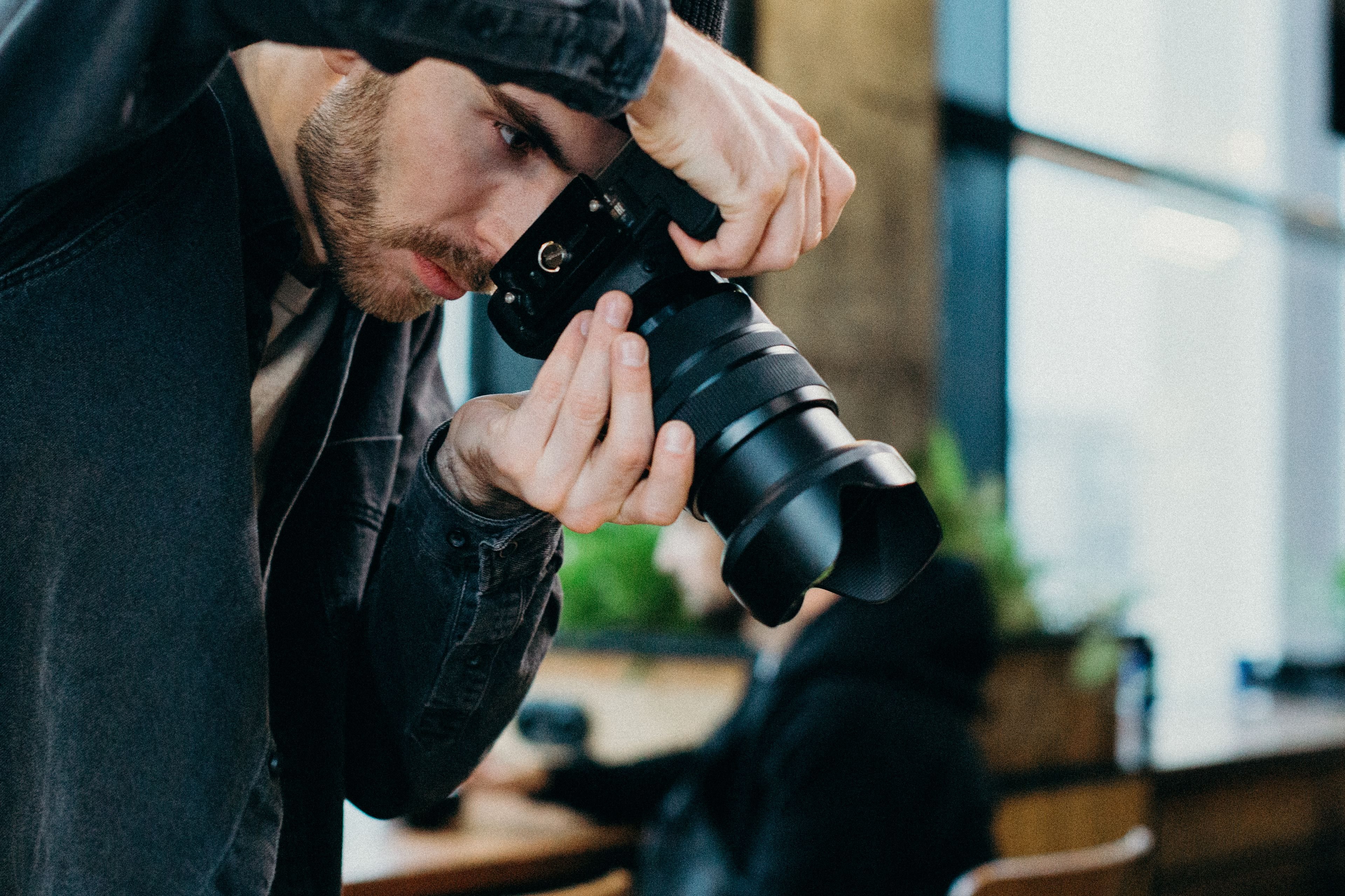 A professional photographer composing a shot with a mirrorless camera
