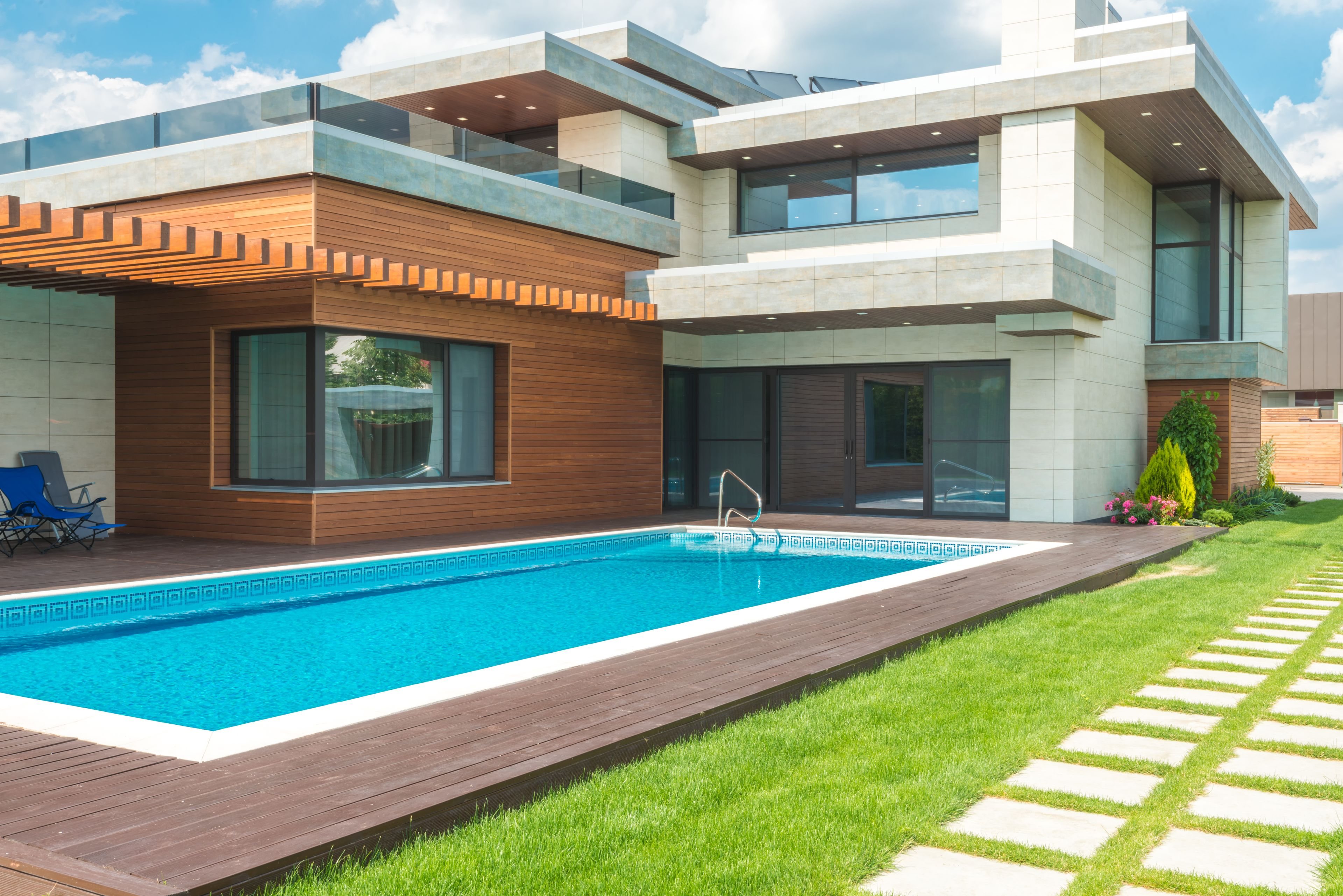 Modern home with a sparkling backyard pool and garden