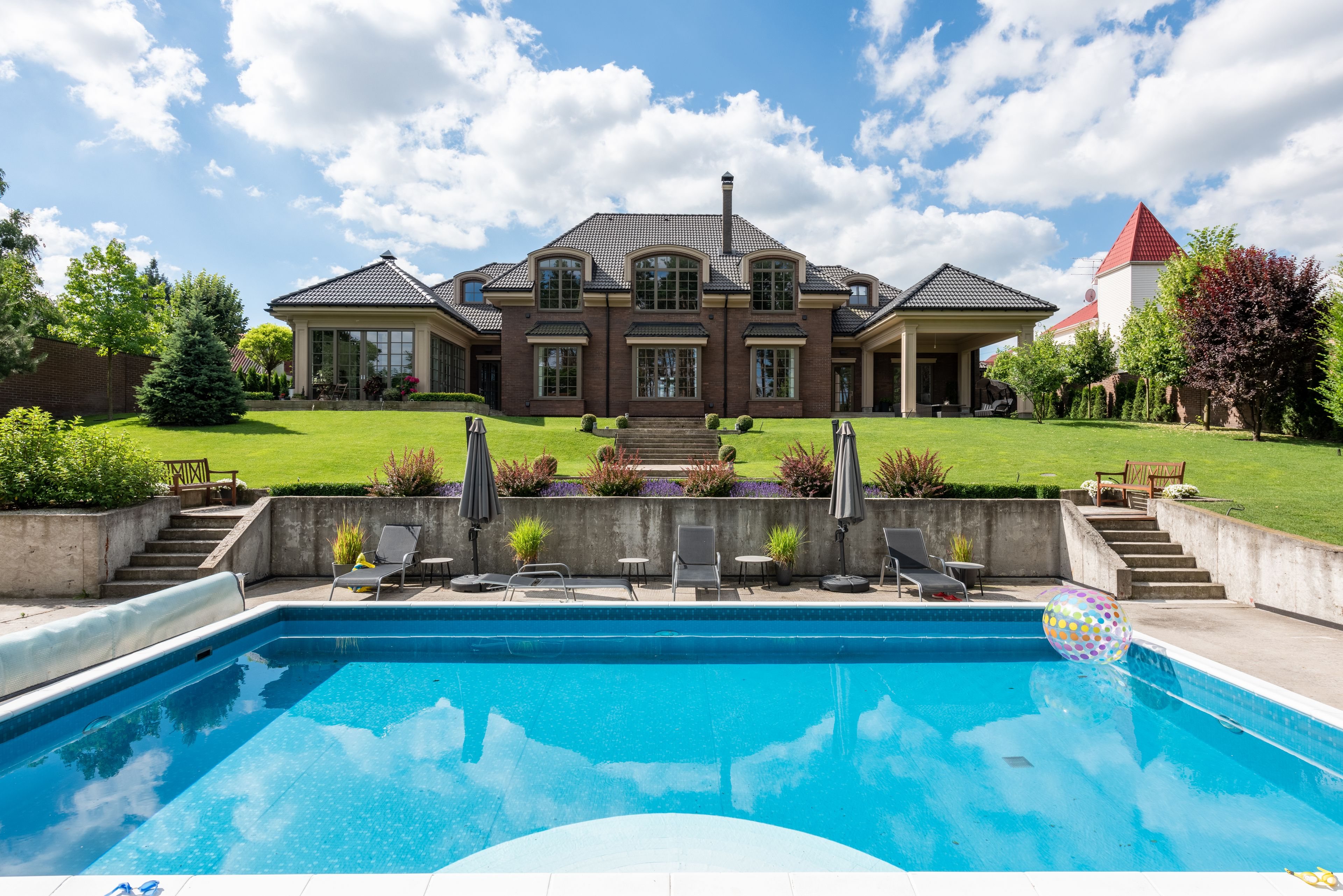 Estate home with a resort-style pool and manicured garden
